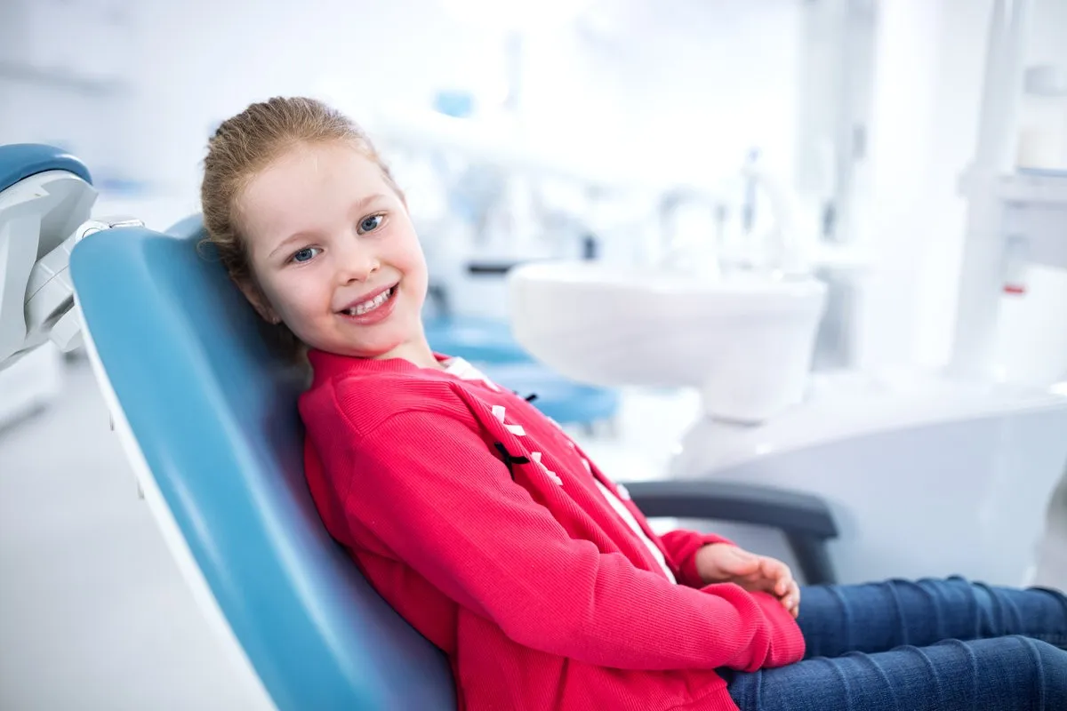 Child smiling after orthodontic checkup at a dental clinic