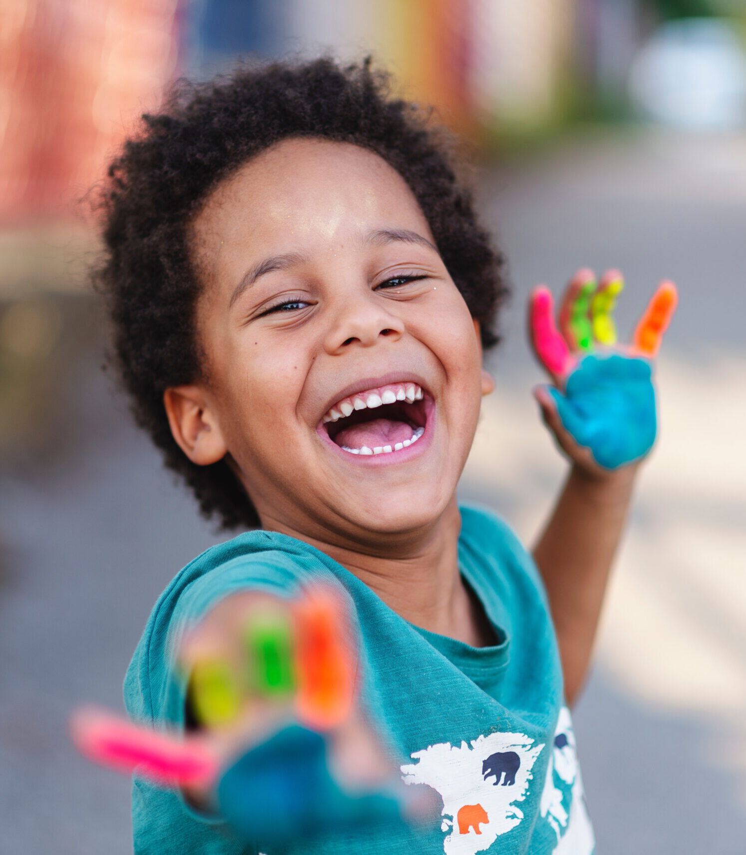 beautiful happy boy with painted hands