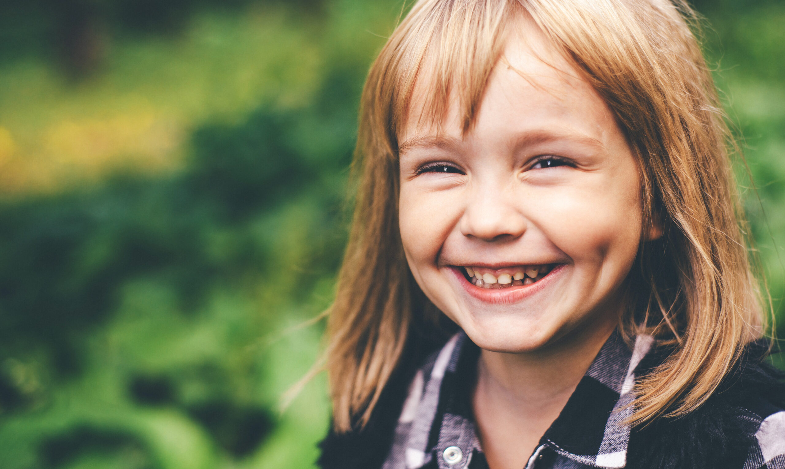 Portrait of a happy smiling child girl. Laughing child. Expressive facial expressions. Black and white image. Space for text.