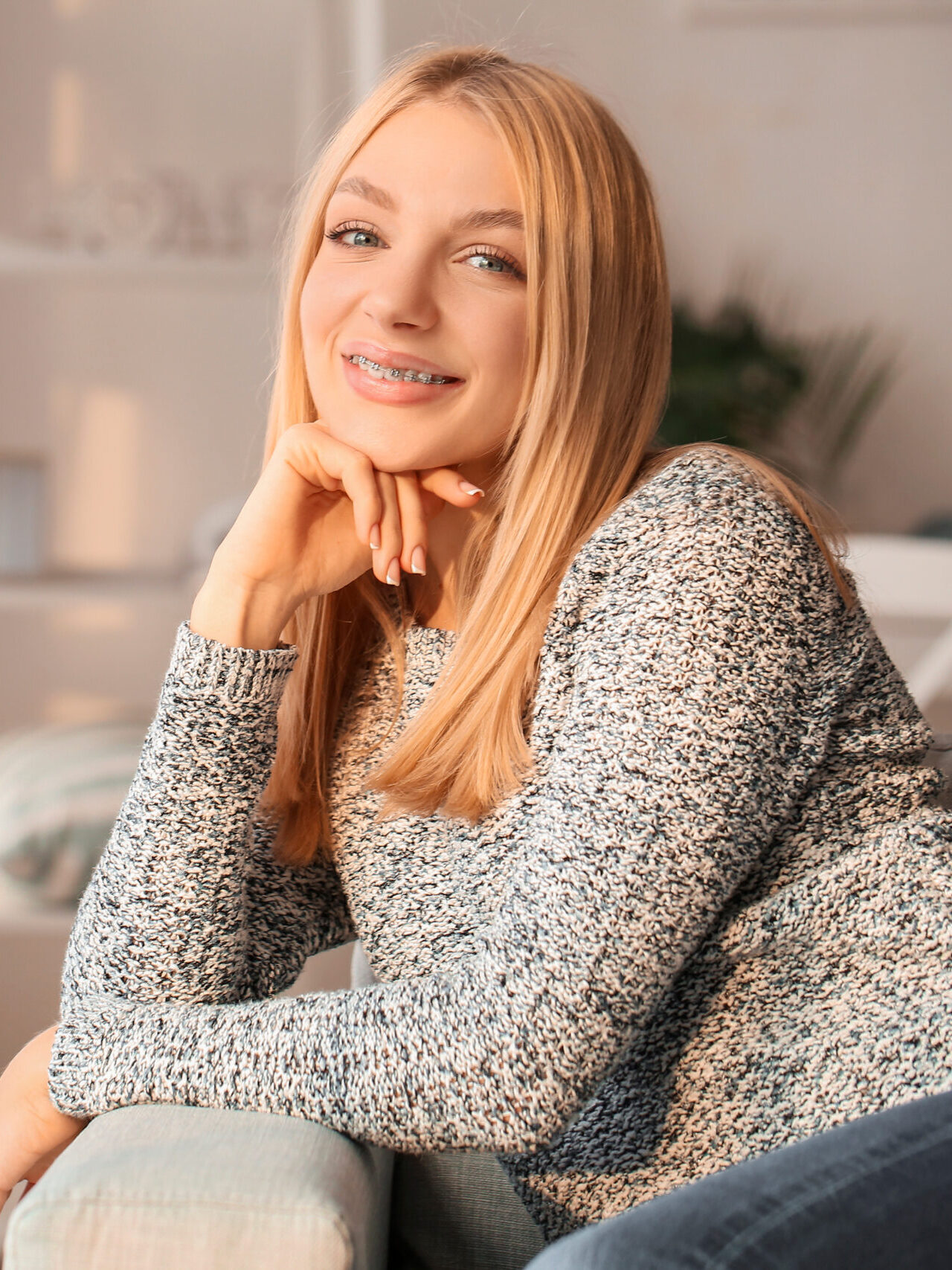 Young woman with dental braces at home