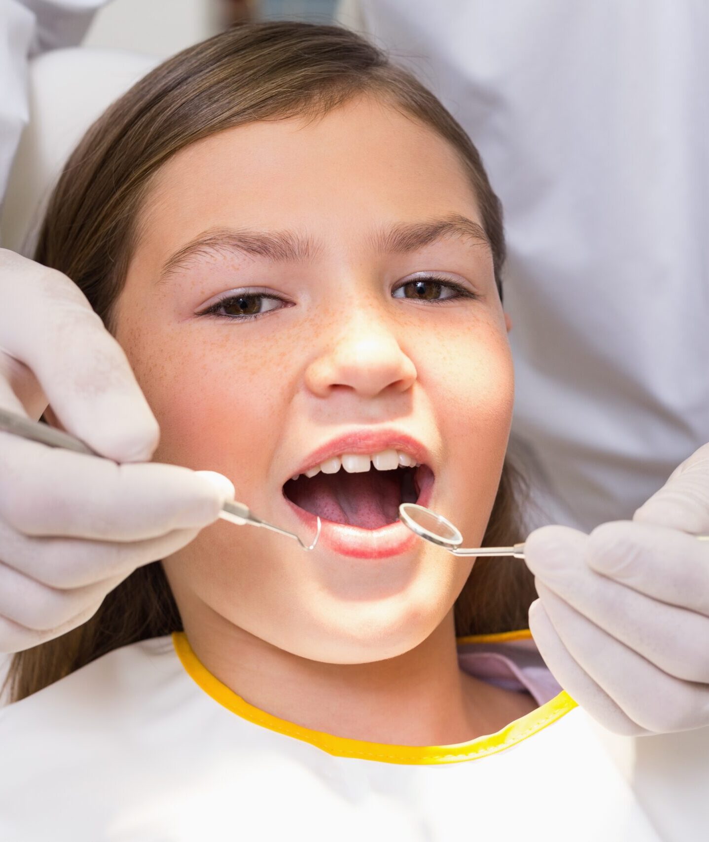 Pediatric dentist examining a patients teeth