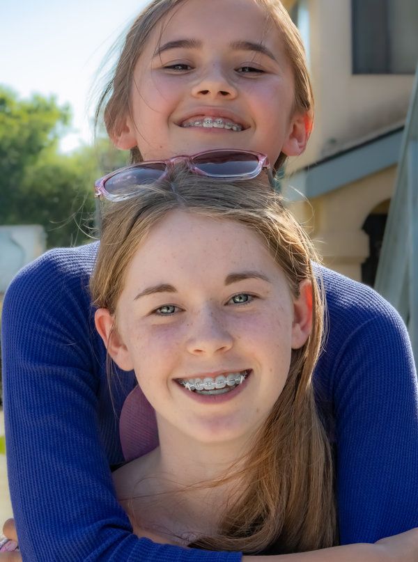 two adult girls having braces