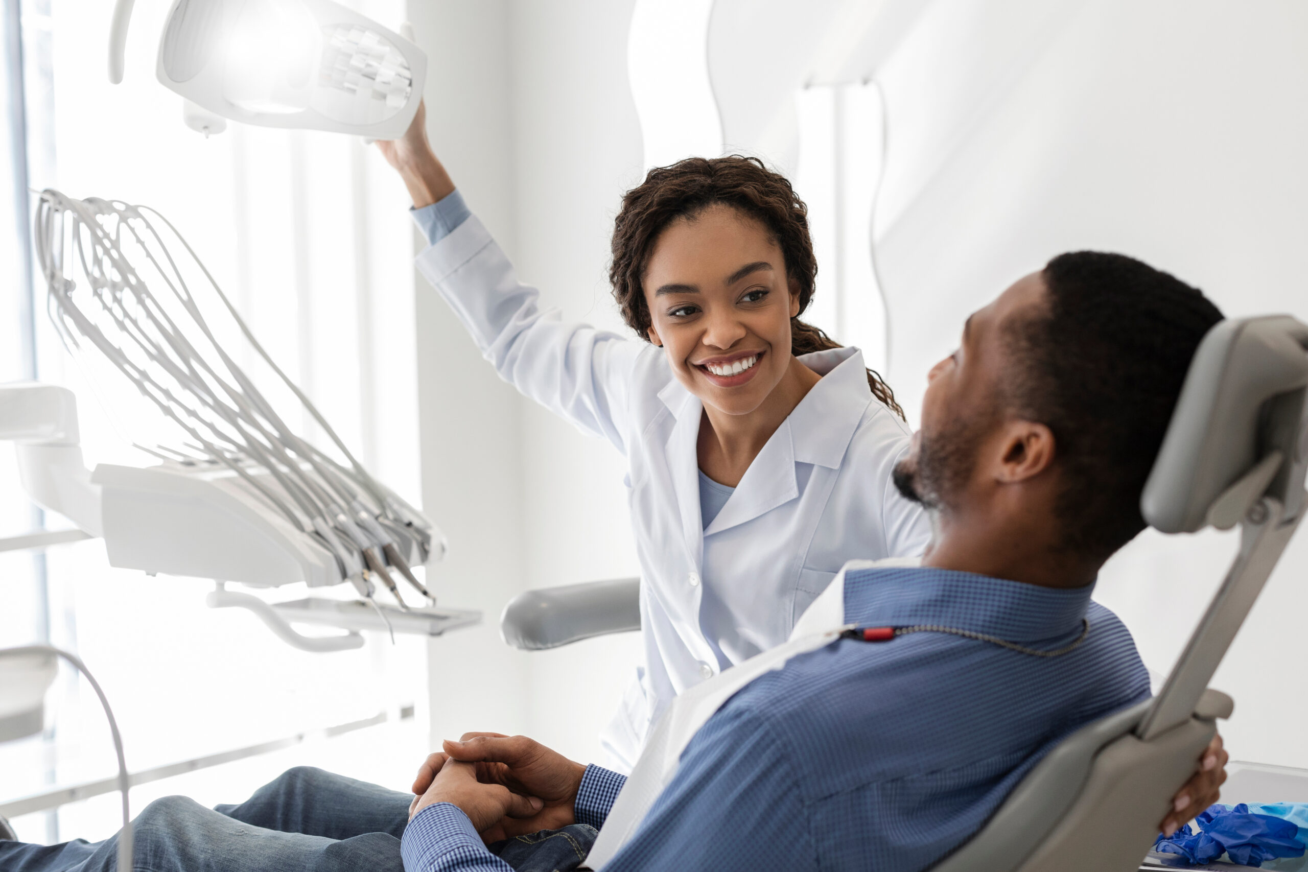 Black orthodontist greeting a patient at Simon Says Smile Orthodontics